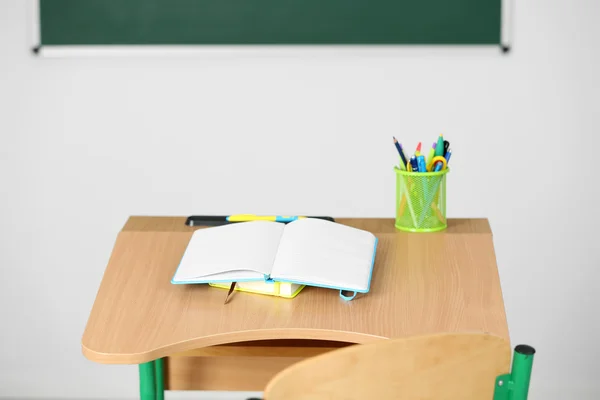 Wooden desk with stationery and chair — Stock Photo, Image