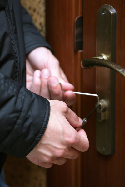 Burglar breaking into house