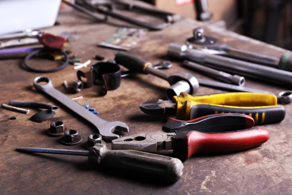 Different tools on workplace in garage — Stock Photo, Image