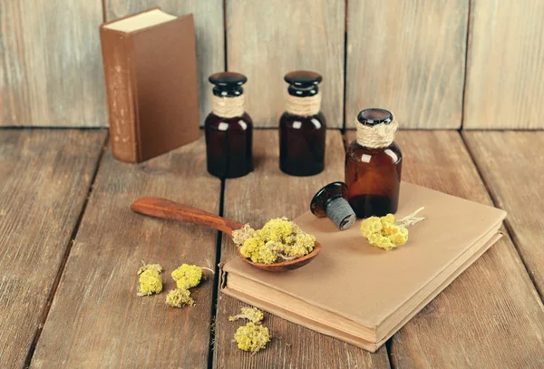 Old books with dry flowers and bottles — Stock Photo, Image