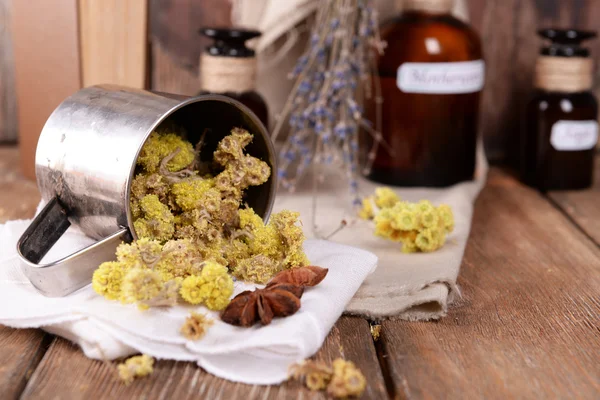Dried herbs and bottles — Stock Photo, Image