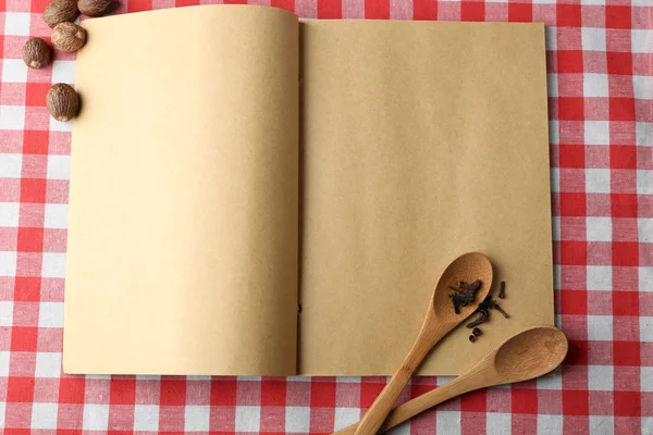 Open recipe book on color tablecloth background — Stock Photo, Image