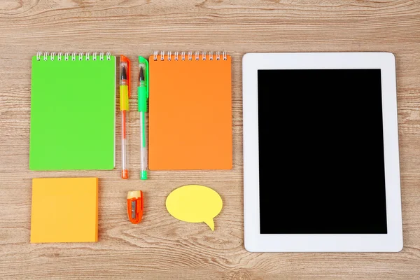 Digital tablet with stationery on wooden background — Stock Photo, Image