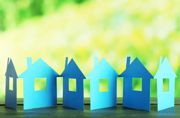 Paper houses on bright blurred background — Stock Photo, Image