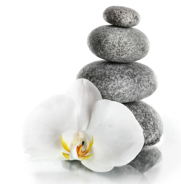 Empilement de pierres de spa avec fleur d'orchidée isolée sur blanc — Photo