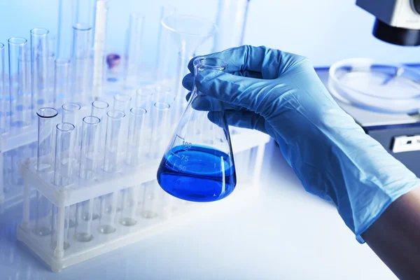 Test tube in scientist hand in laboratory — Stock Photo, Image