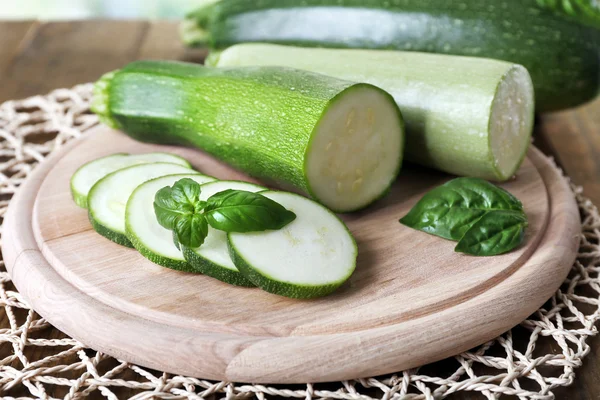 Fresh zucchini with squash and basil on table close up — Stock Photo, Image