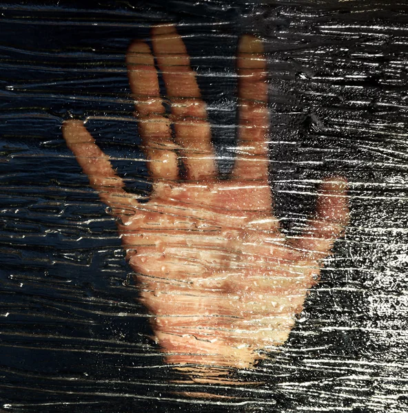 Female hand behind frosted glass, close-up — Stock Photo, Image