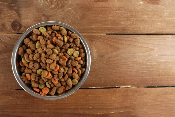 Dog food in bowl on wooden table — Stock Photo, Image