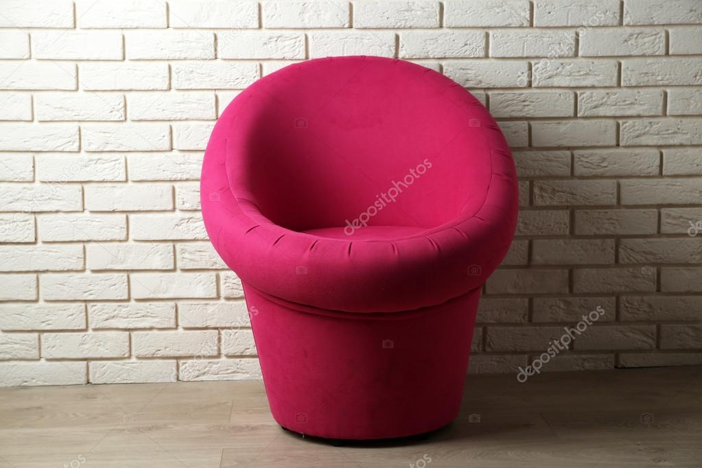 Modern chair on brick wall background