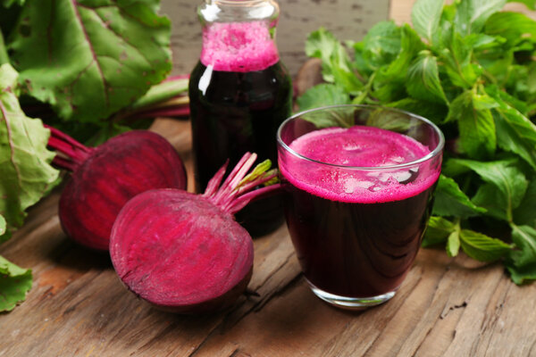 Fresh beet juice on wooden table, closeup