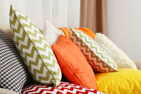 Sofa with colorful pillows in room — Stock Photo, Image