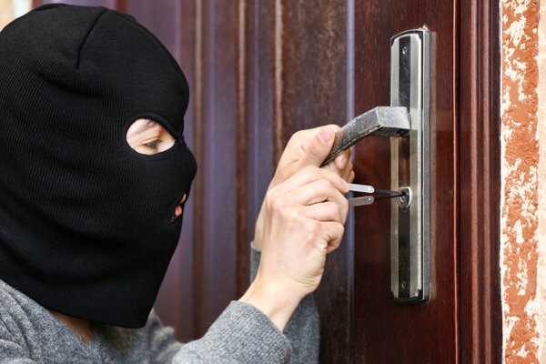 Burglar breaking into house