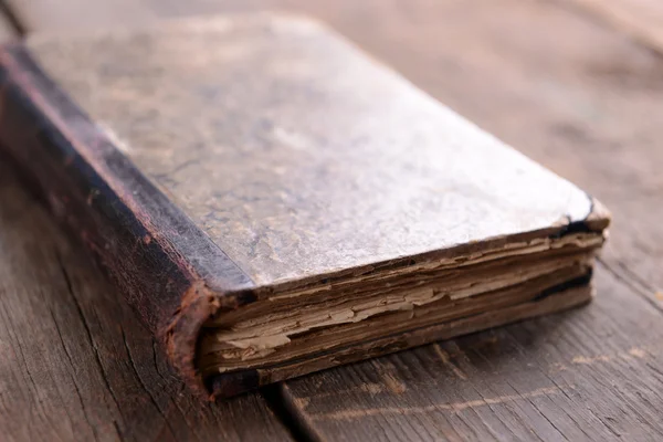 Old book on wooden table close up — Stock Photo, Image