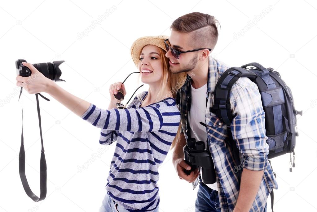 Pair of travelers with camera isolated on white