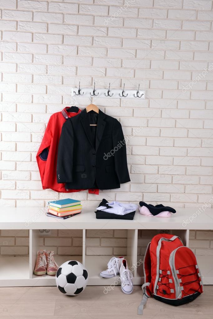 Children things hanging on wall and stacked in room