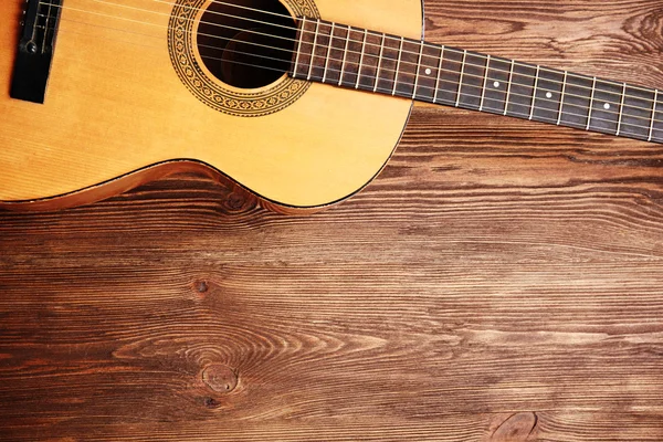 Acoustic guitar on wooden background — Stock Photo, Image