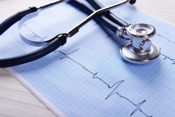 Cardiogram with stethoscope on table — Stock Photo, Image