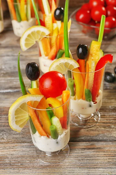 Snack of vegetables in glassware on wooden table, closeup — Stock Photo, Image