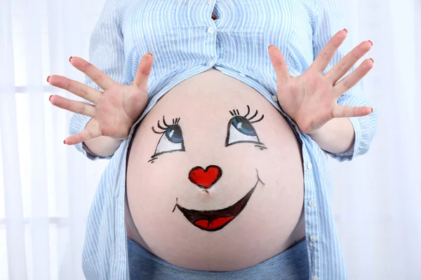 Body art on belly of pregnant woman on light background — Stock Photo, Image