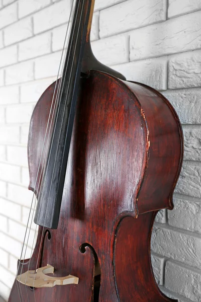 Cello on bricks wall background — Stock Photo, Image