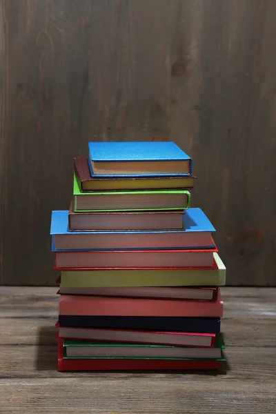 木製の背景のテーブルに書籍のスタック — ストック写真