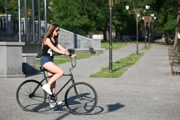 Beautiful girl with bicycle, outdoors — Stock Photo, Image