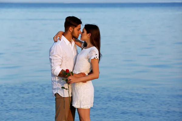 Beautiful young couple on beach — Stock Photo, Image