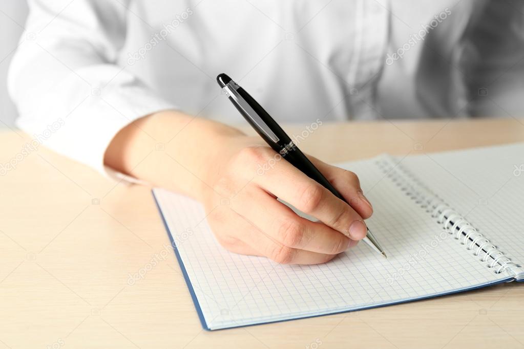 Businesswoman writing on document