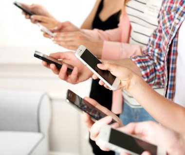 Birçok el cep telefonlarını yakın tutuyor.