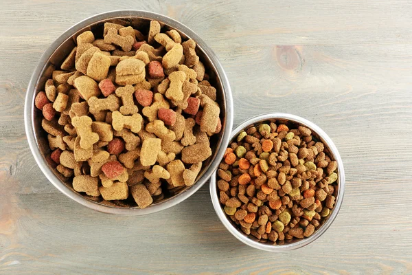 Dog food in bowls on wooden table — Stock Photo, Image