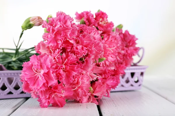 Beautiful bouquet of pink carnation on light background — Stock Photo, Image