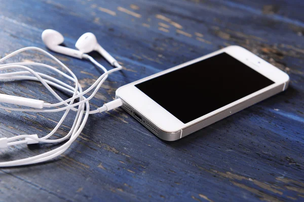 Mobile phone and earphones — Stock Photo, Image