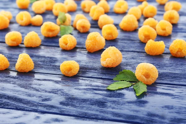 Yellow raspberries on blue wooden background — Stock Photo, Image