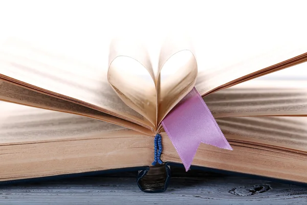 Pages of book curved into heart shape — Stock Photo, Image