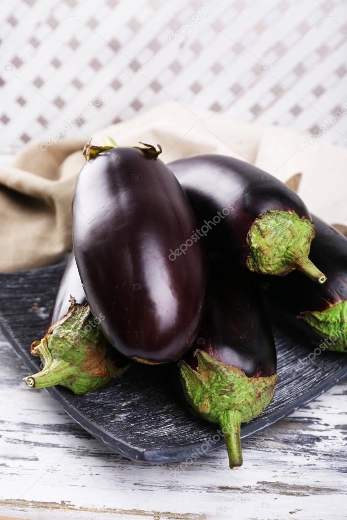 Fresh eggplant on wooden table, closeup