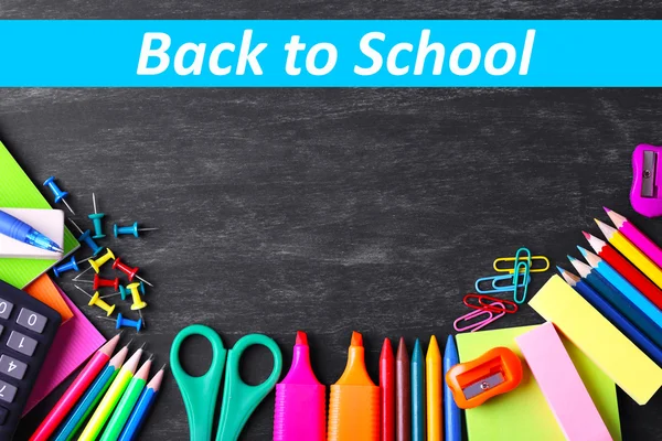 School supplies on blackboard background — Stock Photo, Image