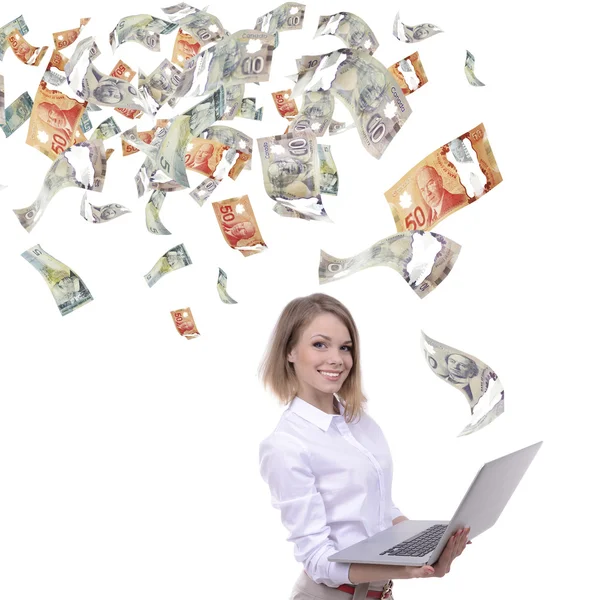 Young business woman with laptop in the rain of money, isolated on white — Stock Photo, Image