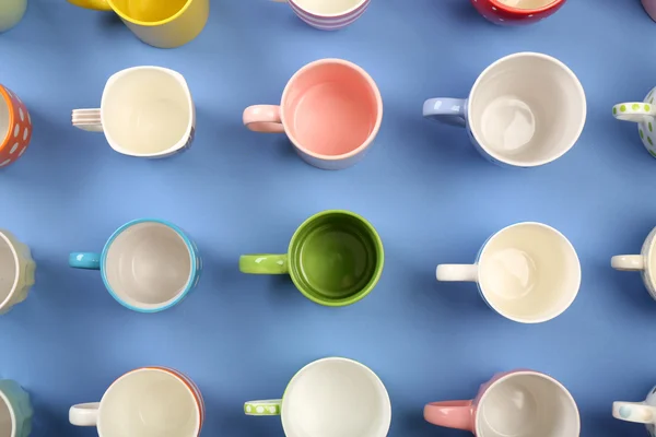 Group of colorful cups on color table, top view — Stock Photo, Image
