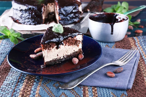 Deliziosa torta al cioccolato con glassa in piatto sul tavolo, primo piano — Foto Stock