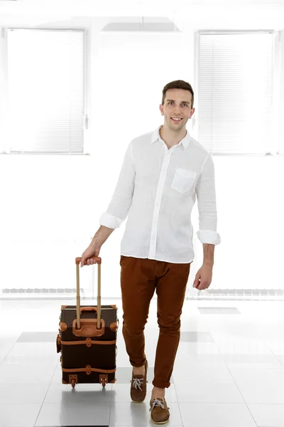 Hombre sosteniendo maleta en el aeropuerto — Foto de Stock