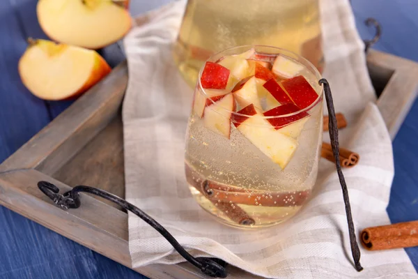 Glass and carafe of apple cider with fruits and spices on table close up — Stock Photo, Image