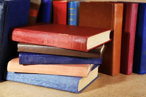 Old books on shelf, close-up, on wooden background — Stock Photo, Image