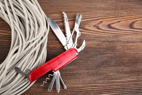 Multipurpose knife on wooden background — Stock Photo, Image