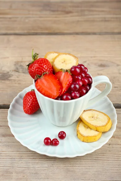 Cup of dessert with fresh fruits on wooden table, closeup — Stock Photo, Image