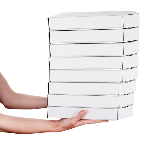 Mãos segurando caixas de pizza isoladas em branco — Fotografia de Stock
