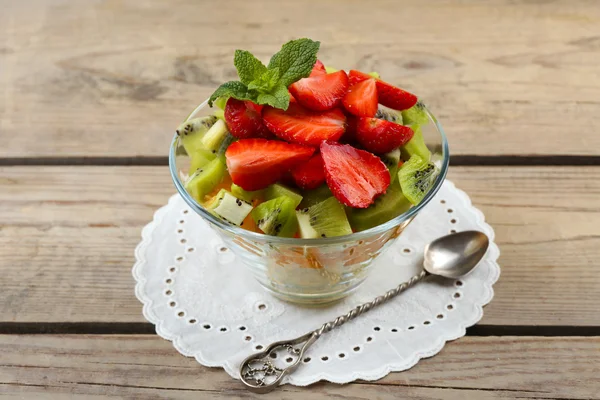 Dessert of fresh fruits in glass saucer on wooden table, closeup — Stock Photo, Image