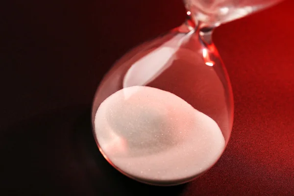 Hourglass on red background — Stock Photo, Image