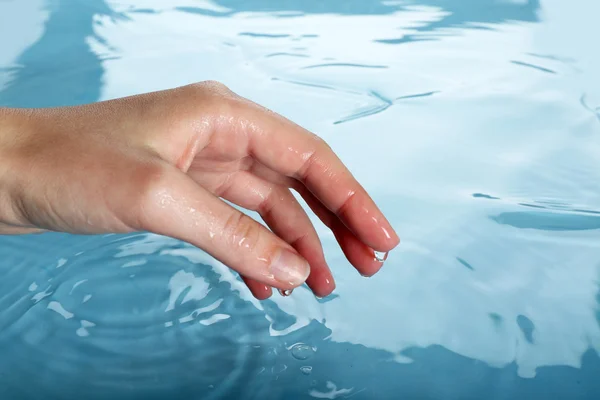 Dedo toca el agua de cerca —  Fotos de Stock