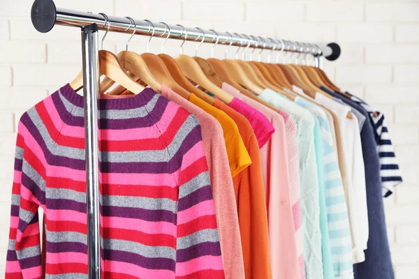 Different clothes on hangers close up — Stock Photo, Image